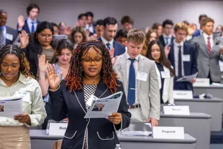 Law students with right hands raised taking oath of professionalism