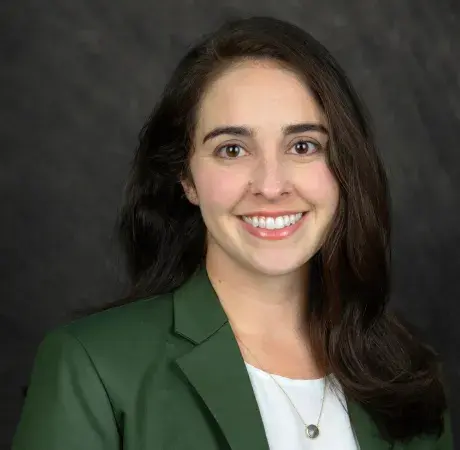 Young lady wearing green blazer facing camera