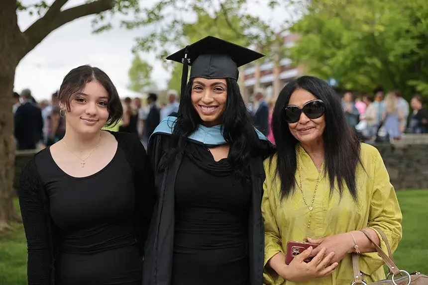 A graduate poses with family