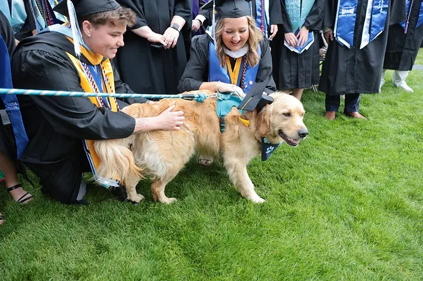 Graduates greet Roger the dog